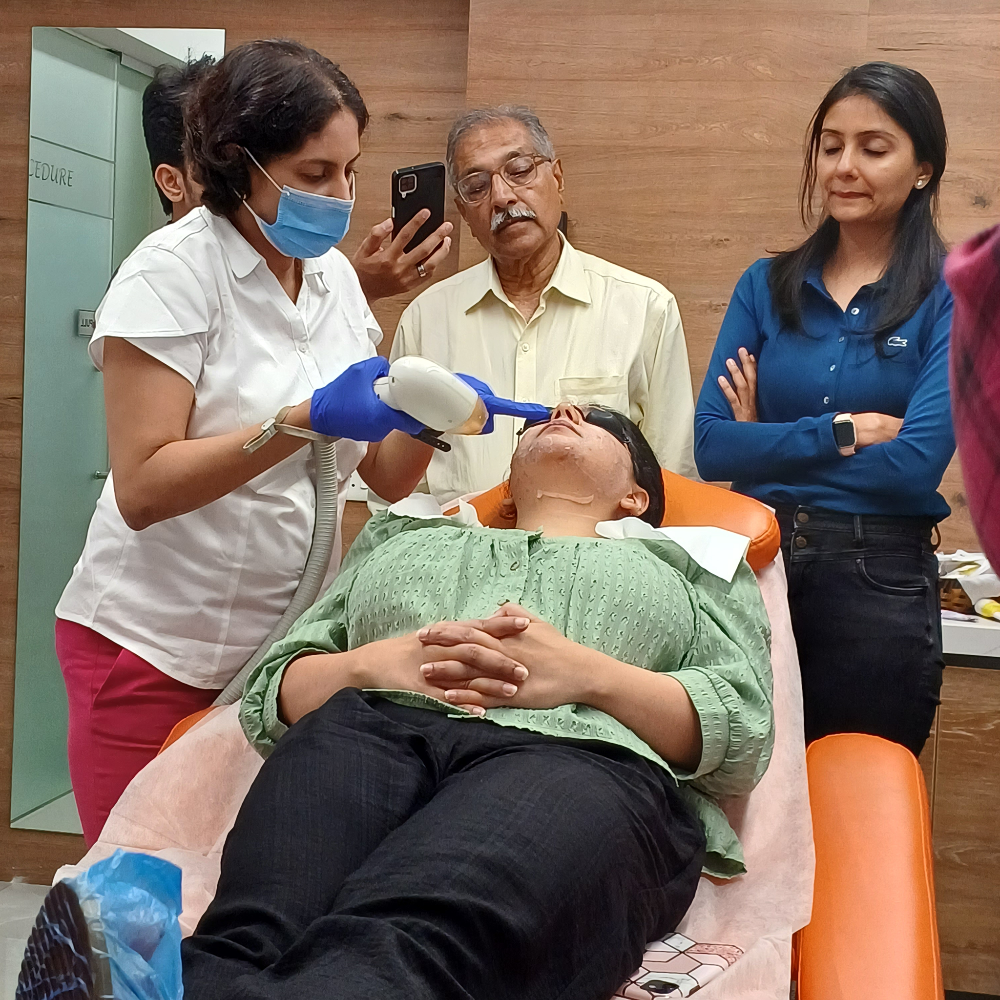 Dr. Rinky Kapoor performing a laser skin treatment procedure in clinic